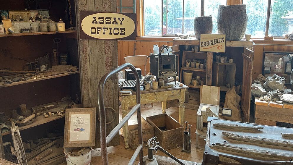 Historical assay office museum exhibit at Big Thunder Gold Mine in Keystone, South Dakota, featuring authentic 1890s gold rush mining equipment, crucibles, ore samples, and vintage tools.