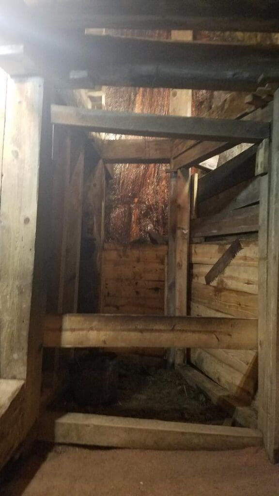 Big Thunder Gold Mine mining museum stope room showing historical wooden timber framing and dark underground tunnel structure.