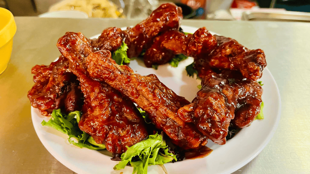 BBQ pork ribs glazed with sticky barbecue sauce served on a bed of lettuce at Big Thunder Bar and Grill in Keystone, SD near Mount Rushmore.