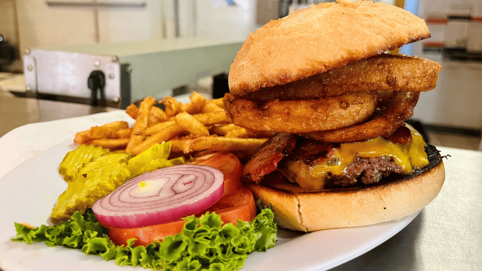 Big Thunder Bar & Grill Western burger with bacon, cheese, onion rings, and french fries at Big Thunder Gold Mine in Keystone, SD