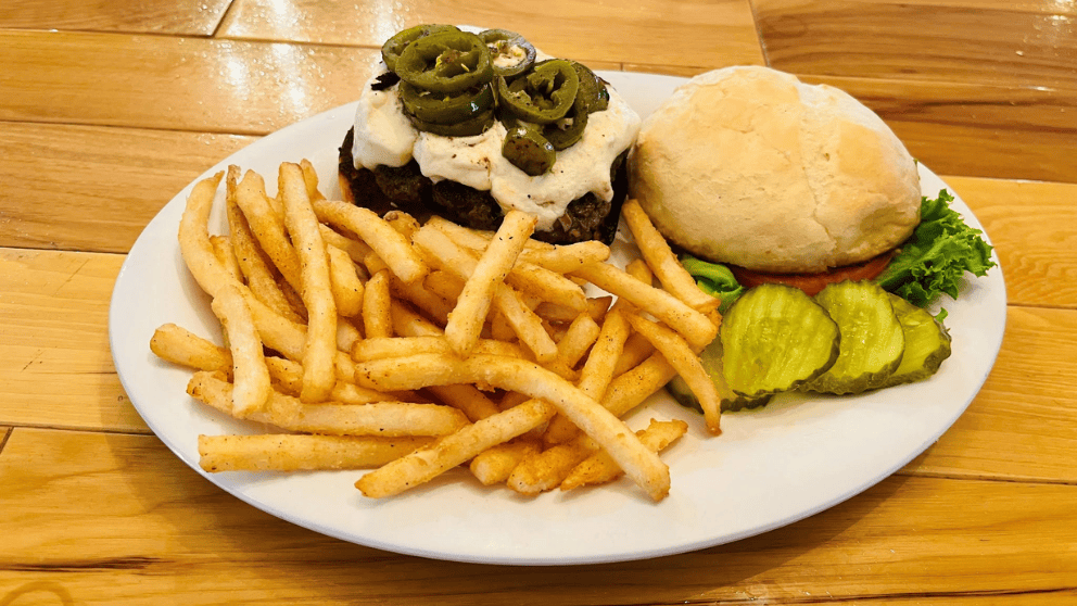 Big Thunder Bar & Grill Jalapeño Popper Burger with melted cream cheese, sliced jalapeños, and a side of french fries at Big Thunder Gold Mine in Keystone, SD